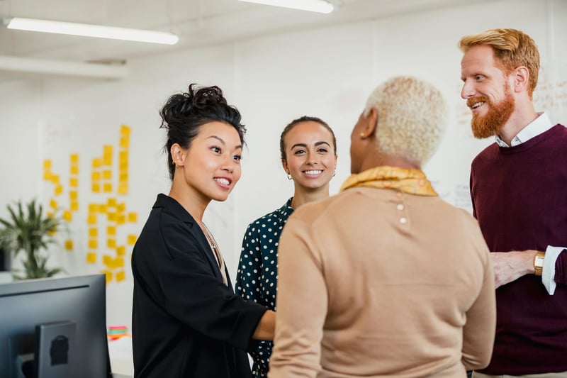 coworkers meeting communicating and shaking hands in an office (1)