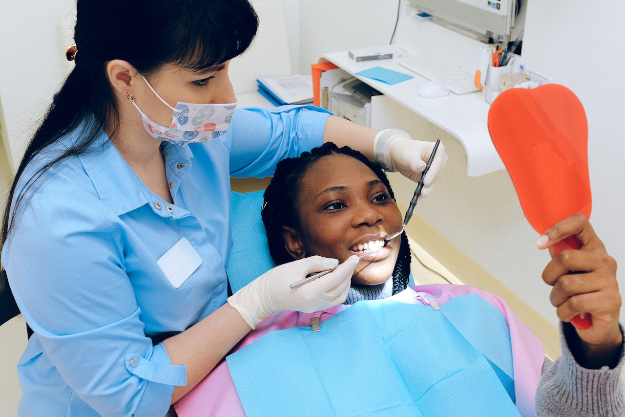 dentist-showing-patient-her-smile-with-mirror-best-work-life-balance-jobs