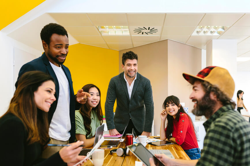 group-of-employees-gathered-around-a-table-employee-recognition