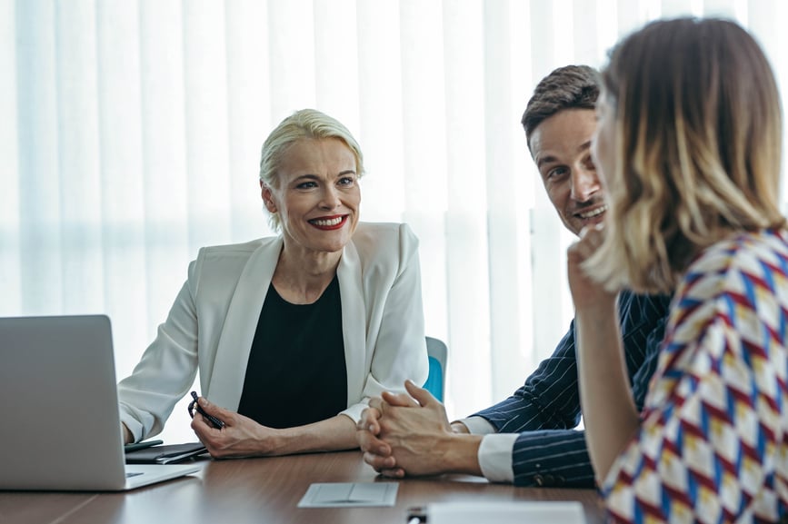 female-leader-sitting-at-meeting room-and-talking-with-her-employees-values-of-a-leader