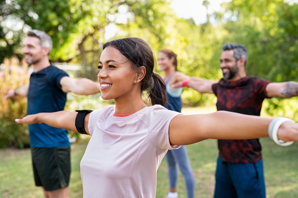 group-of-people-stretching-arms-what-is-brain-fog