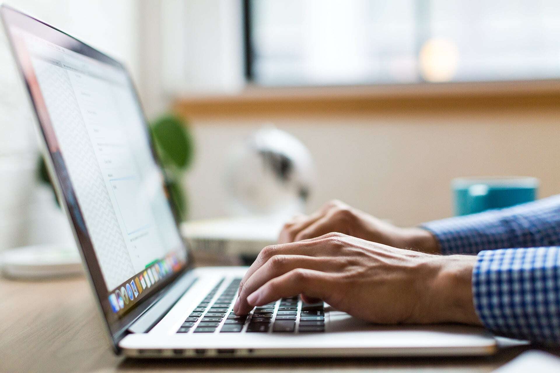 person-typing-on-laptop-using-best-ai-resume-builders