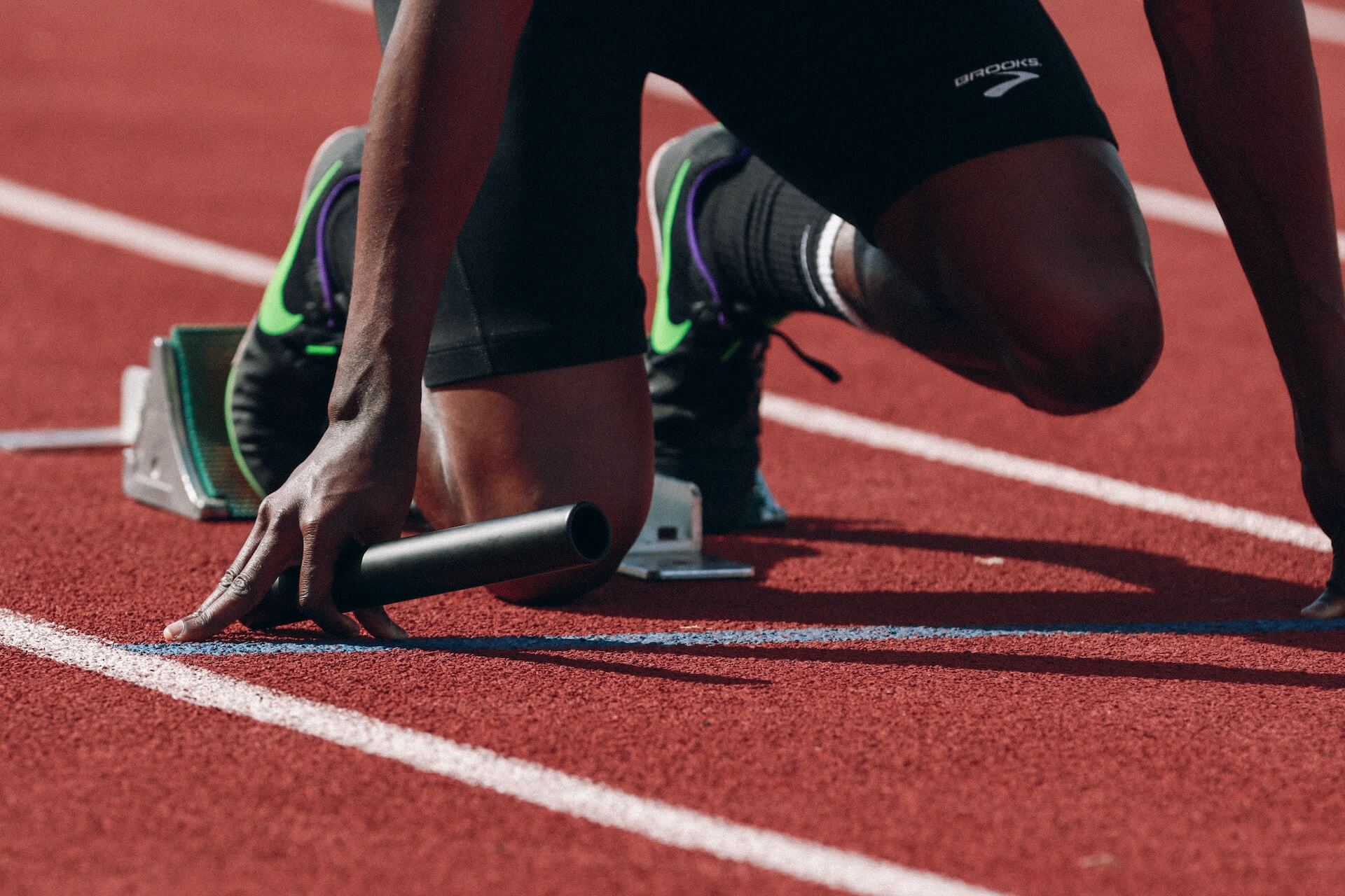 man of color kneeling to race