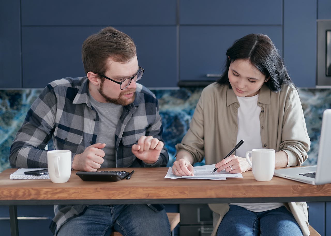 man-and-woman-sitting-at-table-with-documents