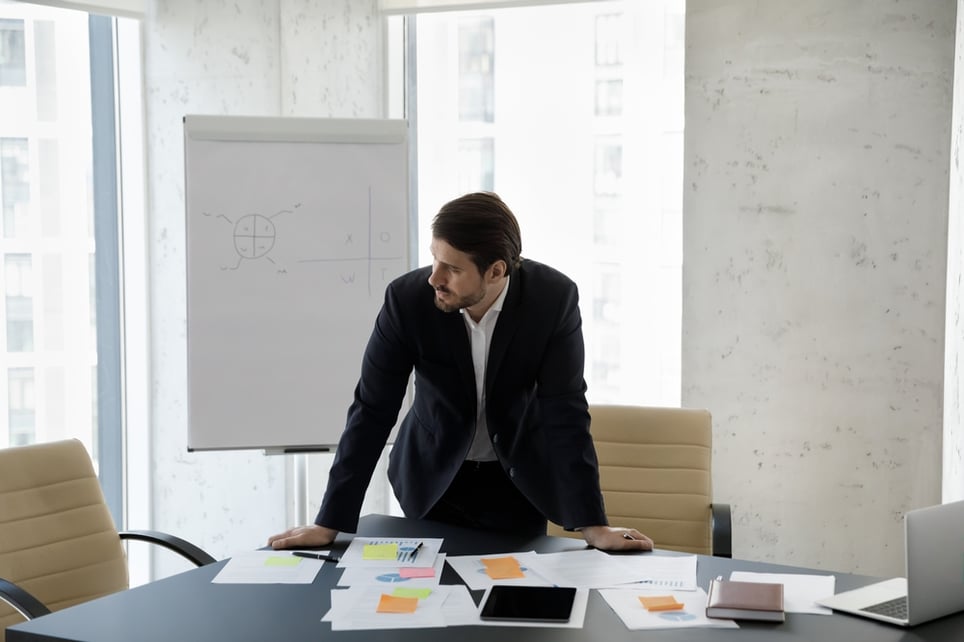 man-in-conference-room-thinking-worried-self-compassion-at-work