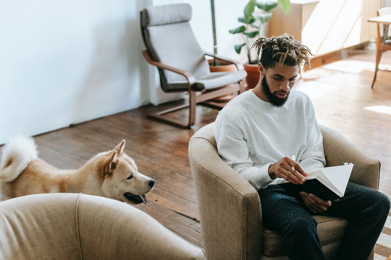 man-journaling-near-dog-the-5am-club