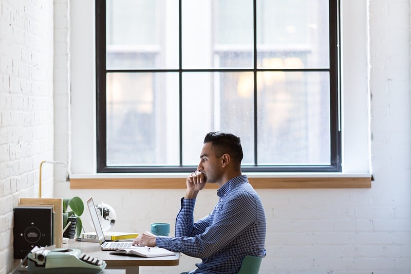 man-sitting-in-desk-in-front-of-computer