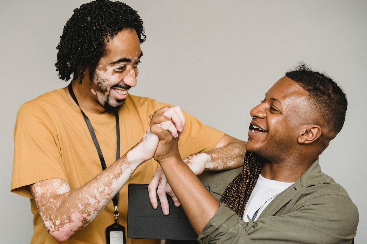 man-stretching-hand-of-this-coworker-smiling-appreciation-for-good-work-messages