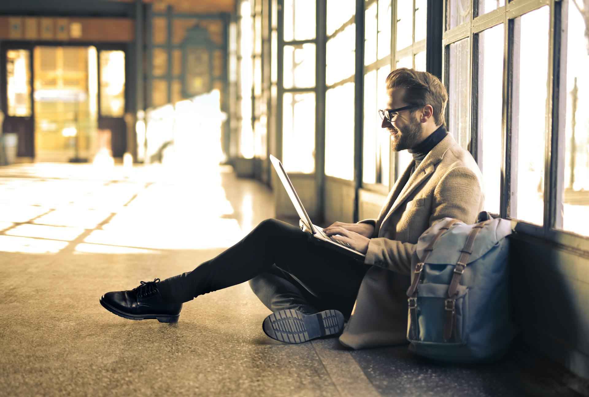 man-working-with-his-computer-in-the-floor-self-actualization-examples