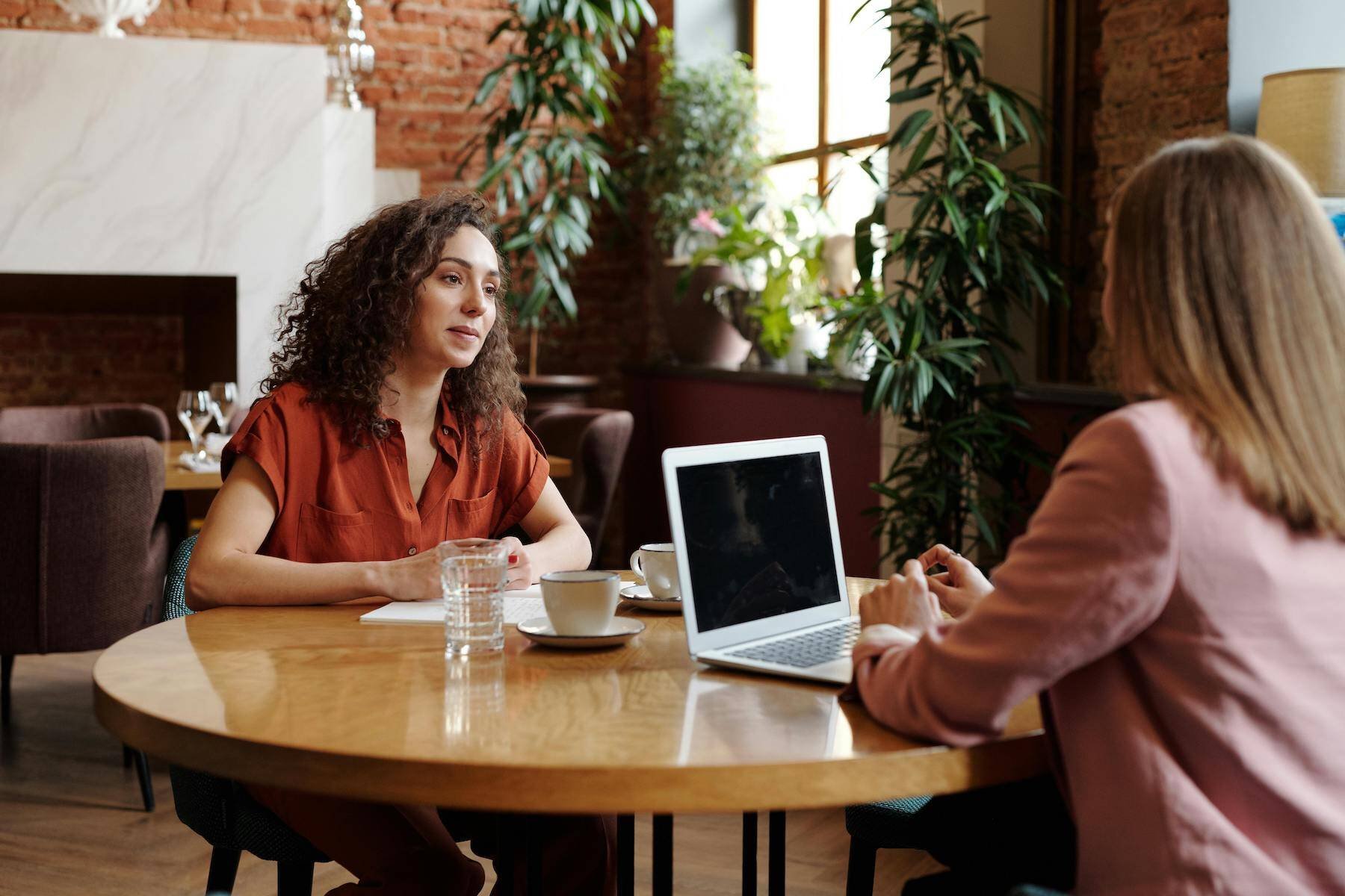 person-sits-at-table-with-employer-for-final-interview-questions