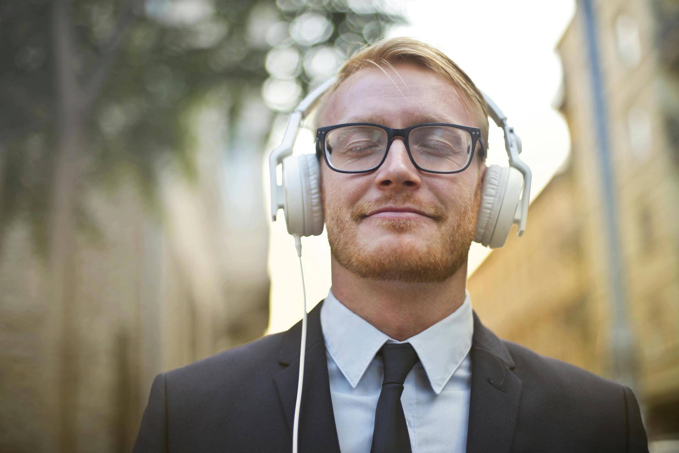 man-using-headphones-to-calm-overstimulation
