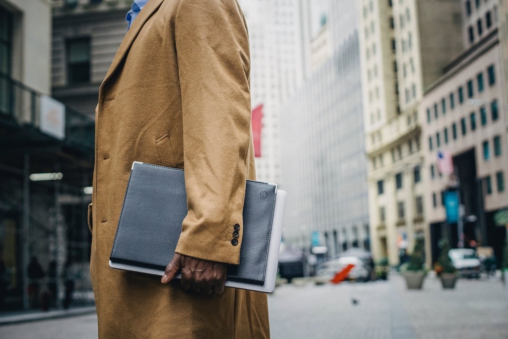 men-holding-a-document-case-standing-on-street-career-trajectory