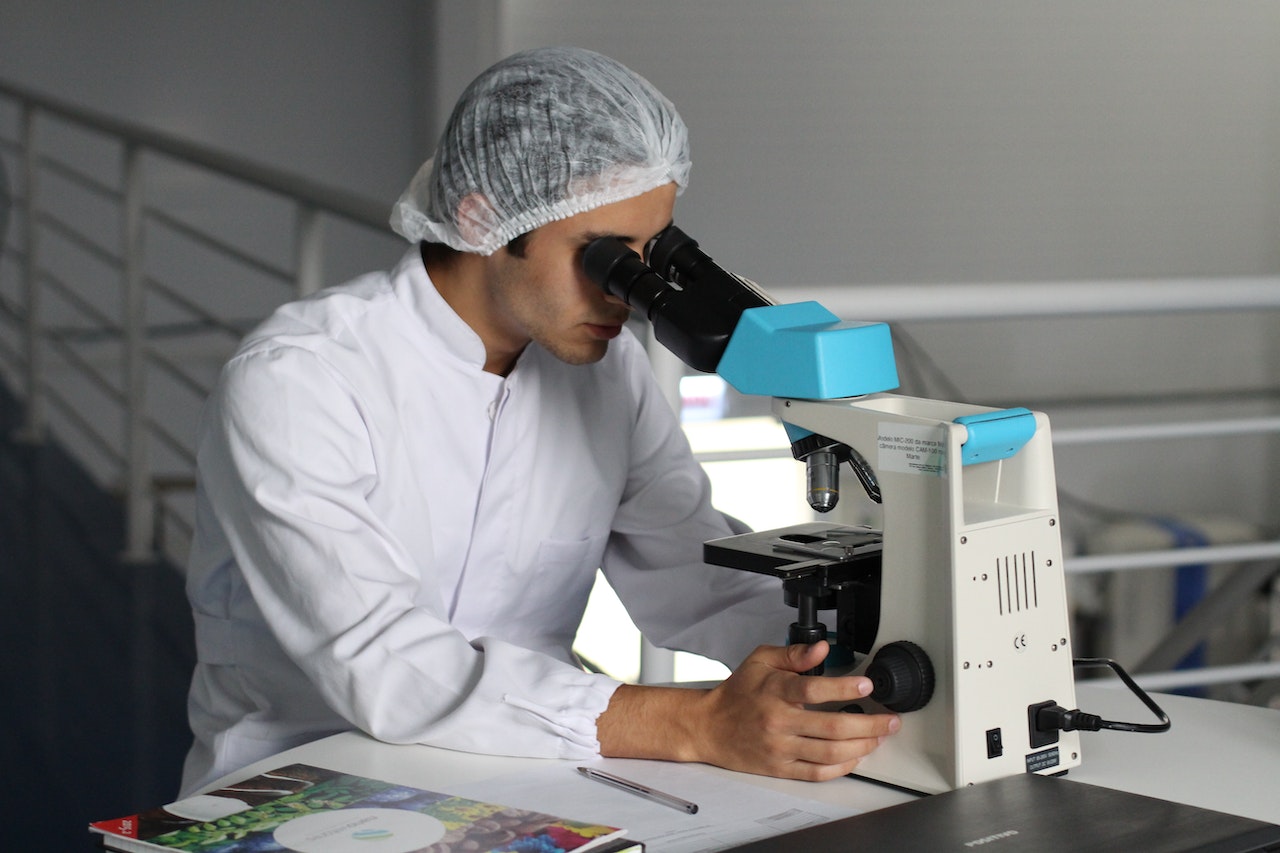 scientist-assistand-looking-through-microscope-with-lab-coat-best-work-life-balance-jobs