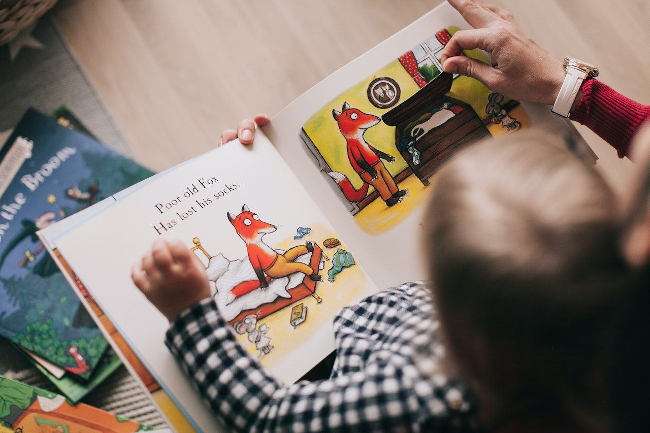 toddler-looking-at-books-with-illustrations-and-colors-parenting-skills