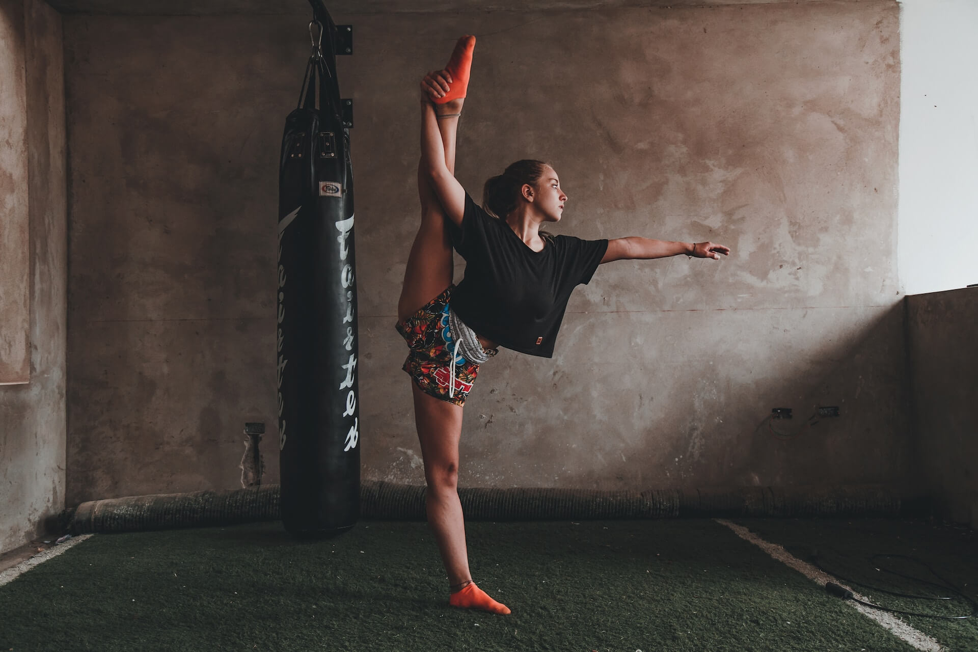 woman athlete standing holding leg in the air