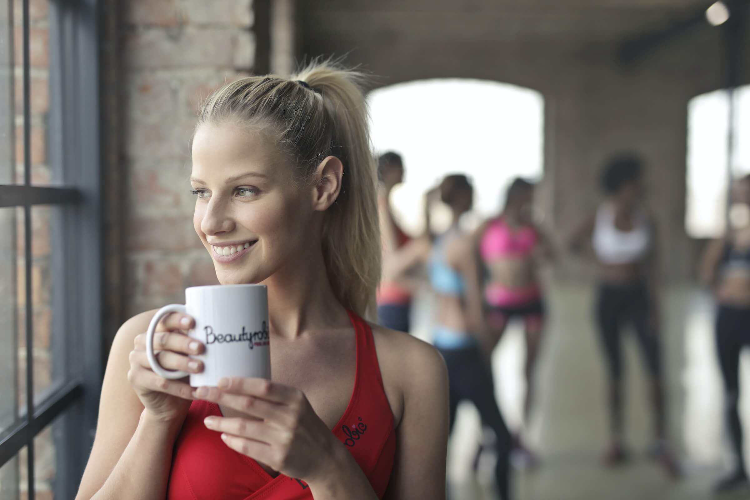 woman drinking coffee before exercising