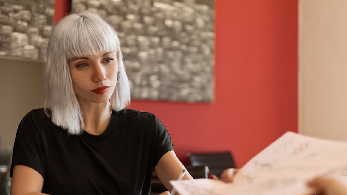 woman in conference room with colleague job-insecurity