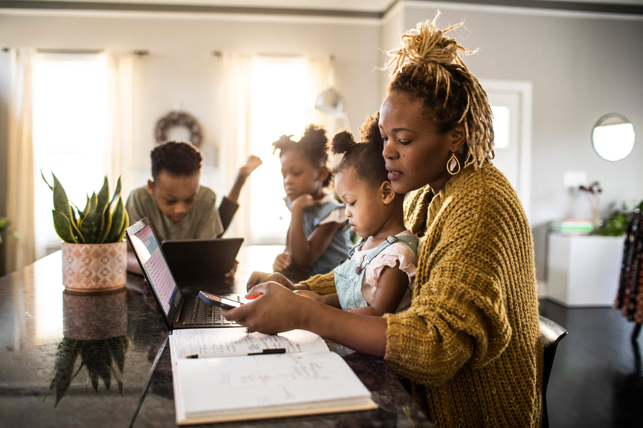 woman working on phone with children showing grit