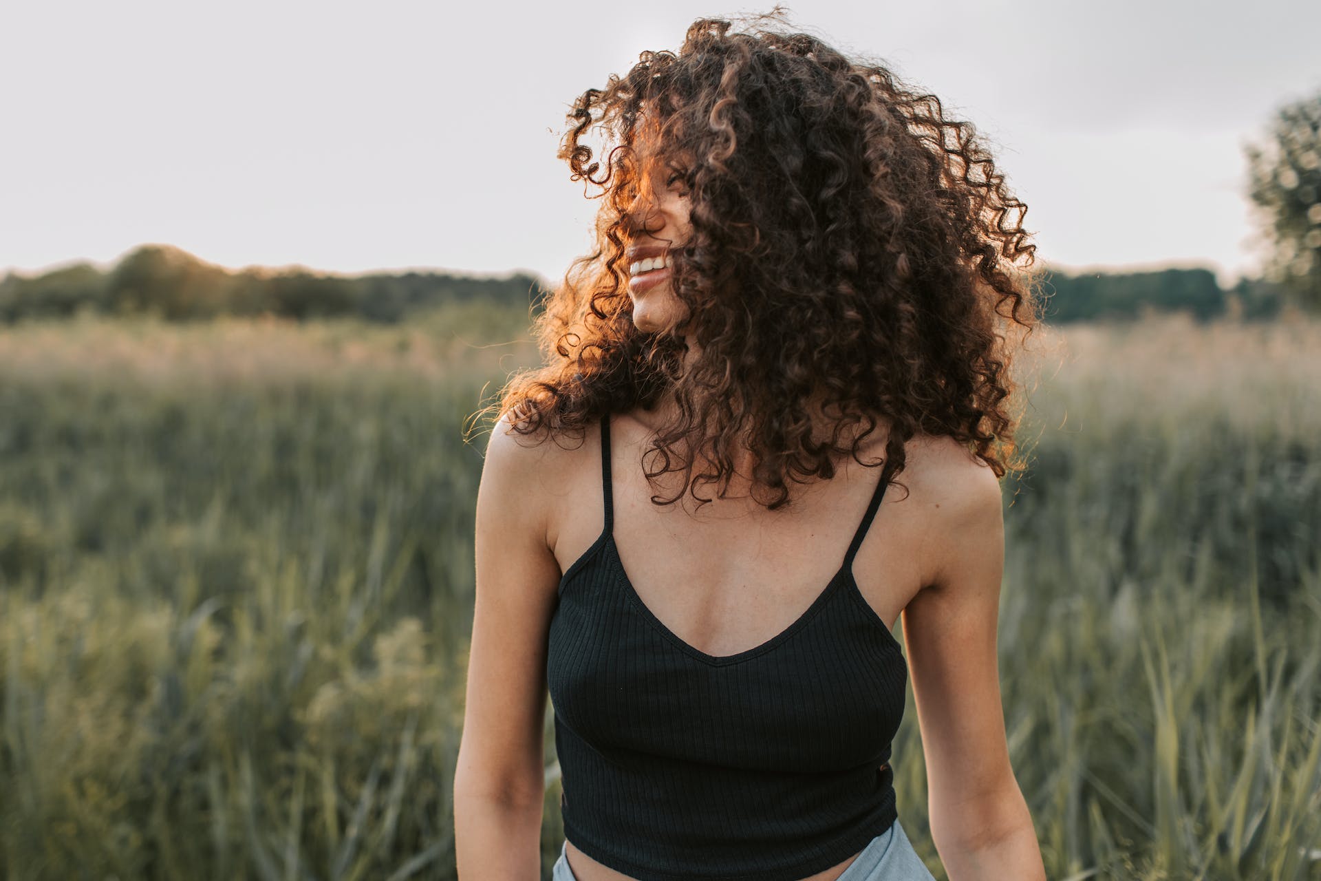 woman-laughing-in-the-field-self-actualization-examples