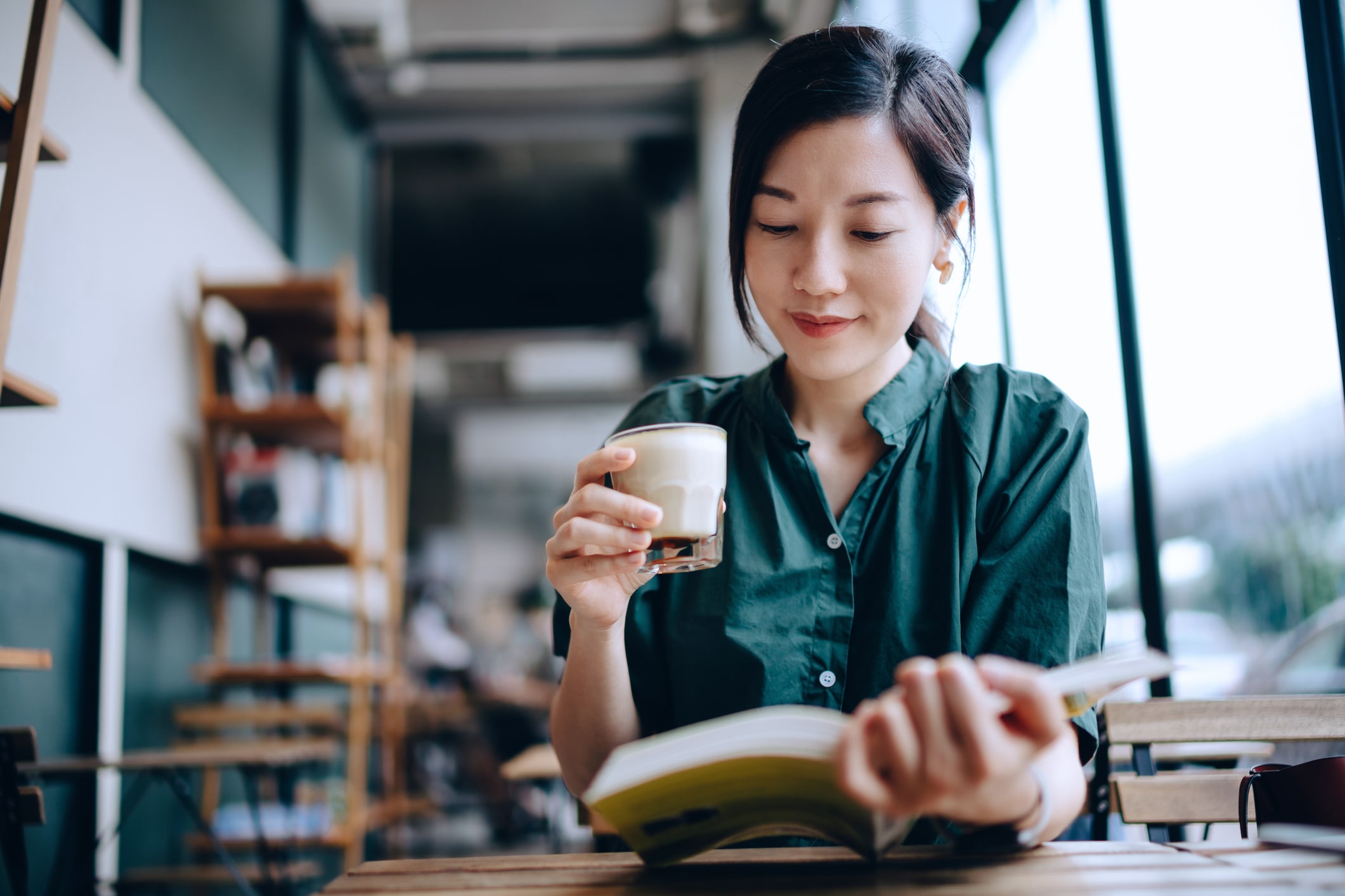 woman-taking-a-break-and-reading-book-in-cafe-finding-purpose-after-college