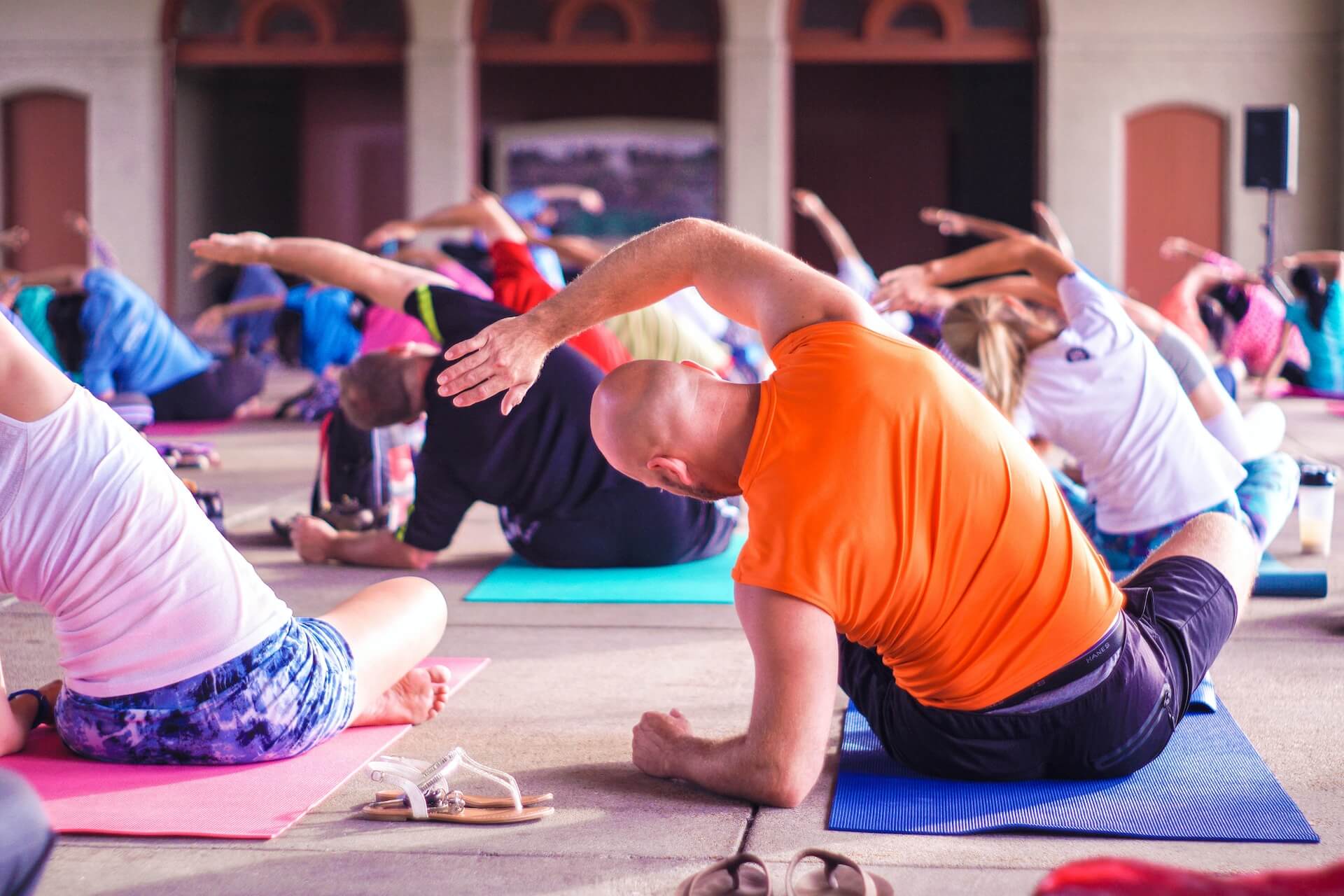 yoga class with people in colorful shirts starting healthy habits