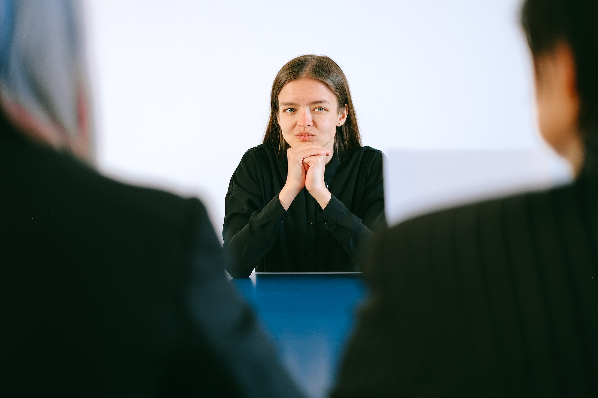 young-woman-in-front-of-two-interviewers-project-management-interview-questions