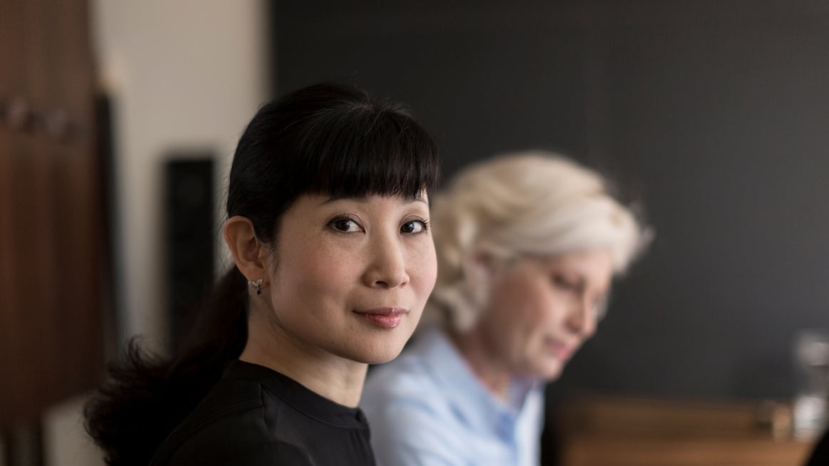 woman looking at camera in a meeting about types of power