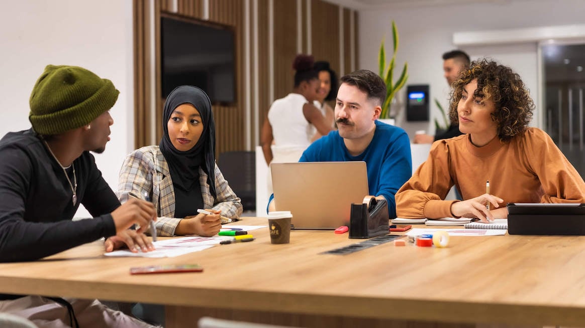 strategic-plan-vs-work-plan-team-meeting-at-table