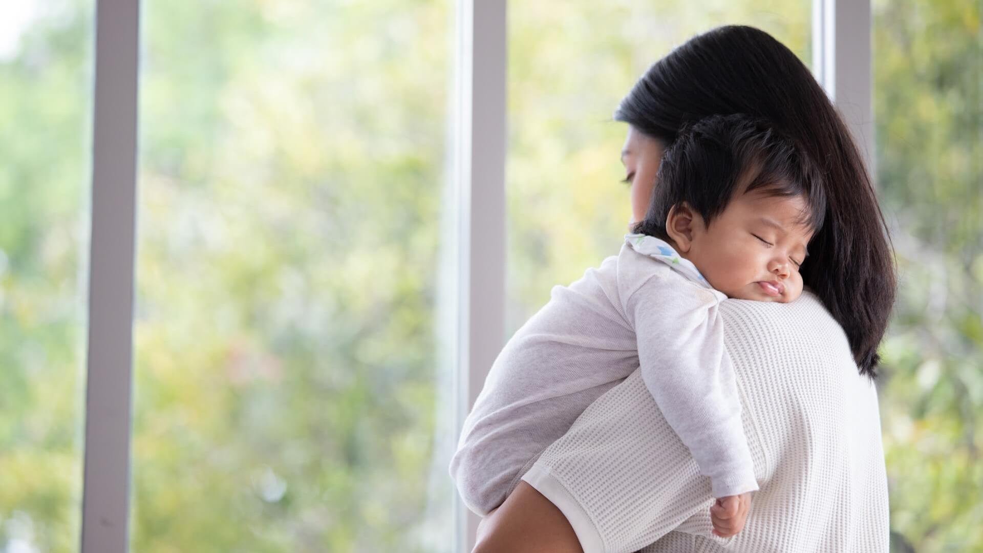 how-to-deal-with-postpartum-depression-tired-mom-holds-baby