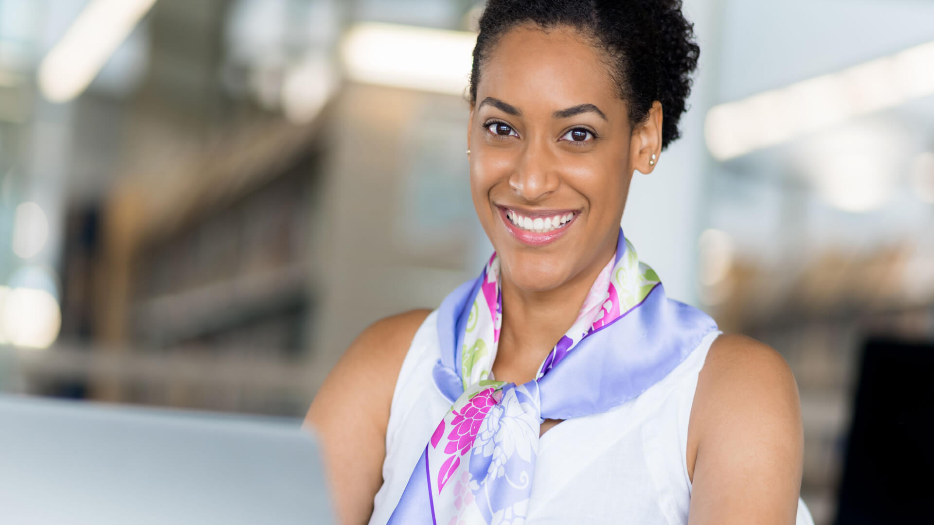 hr-metrics-person-smiling-in-office-with-laptop