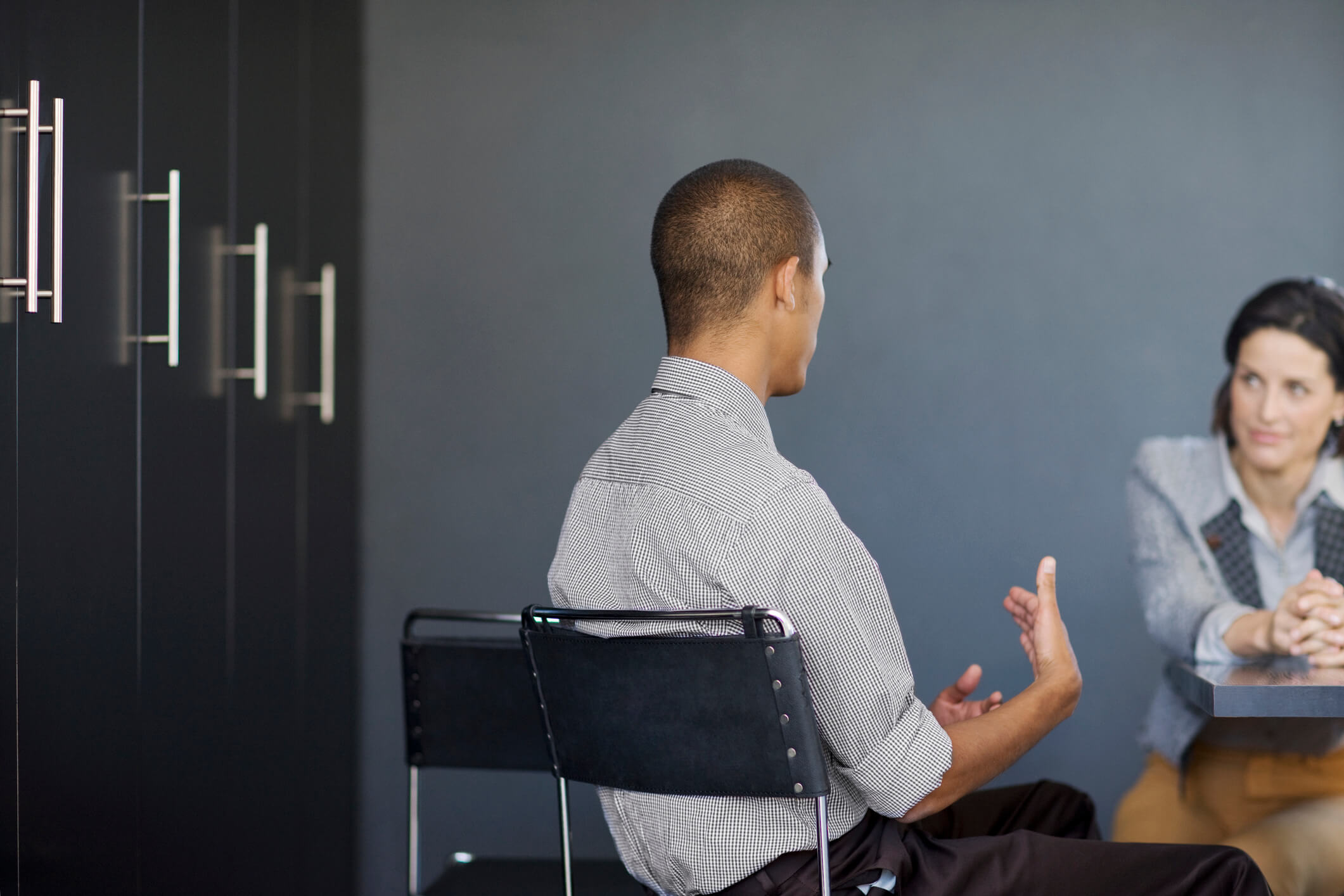 two people at desk discussing pulse survey questions