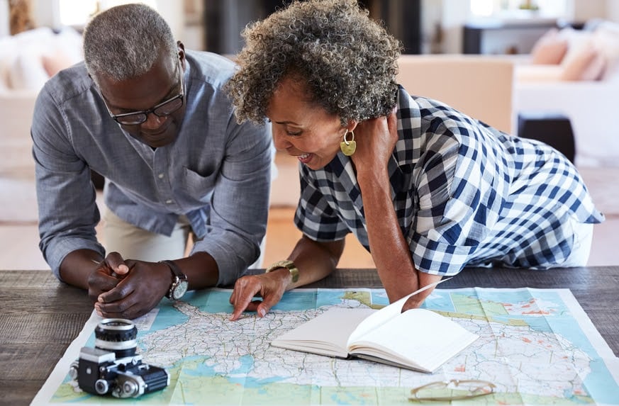 retirement-age-couple-looking-at-map-of-USA-401k-employer-match