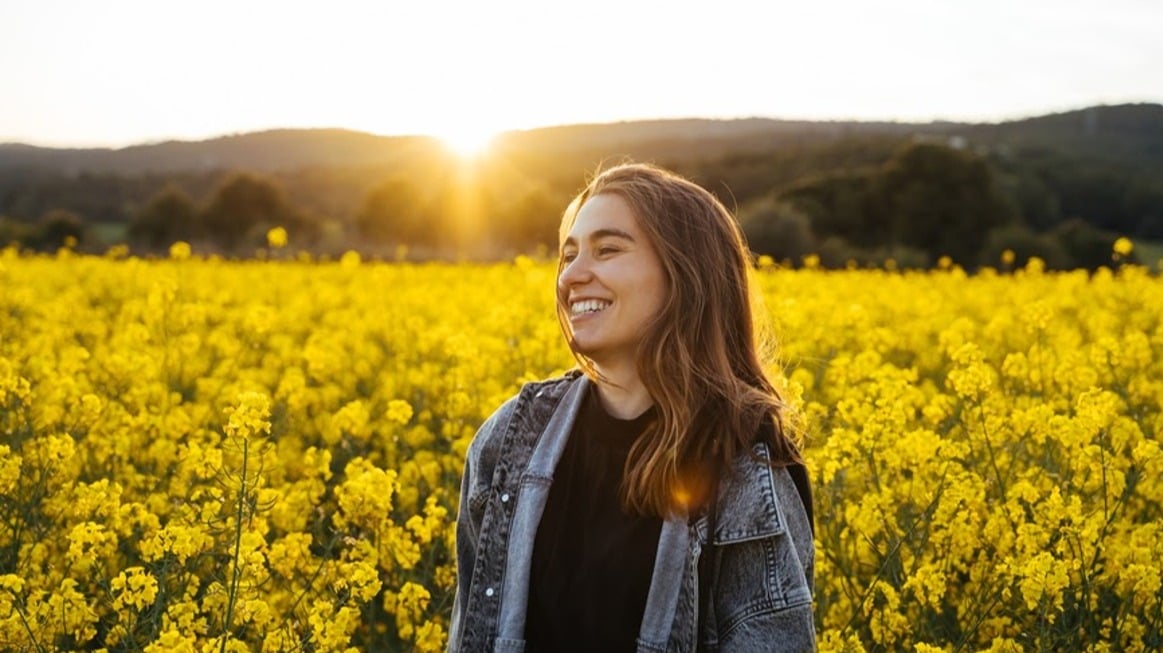 happy-woman-in-field-of-flowers-environmental-health