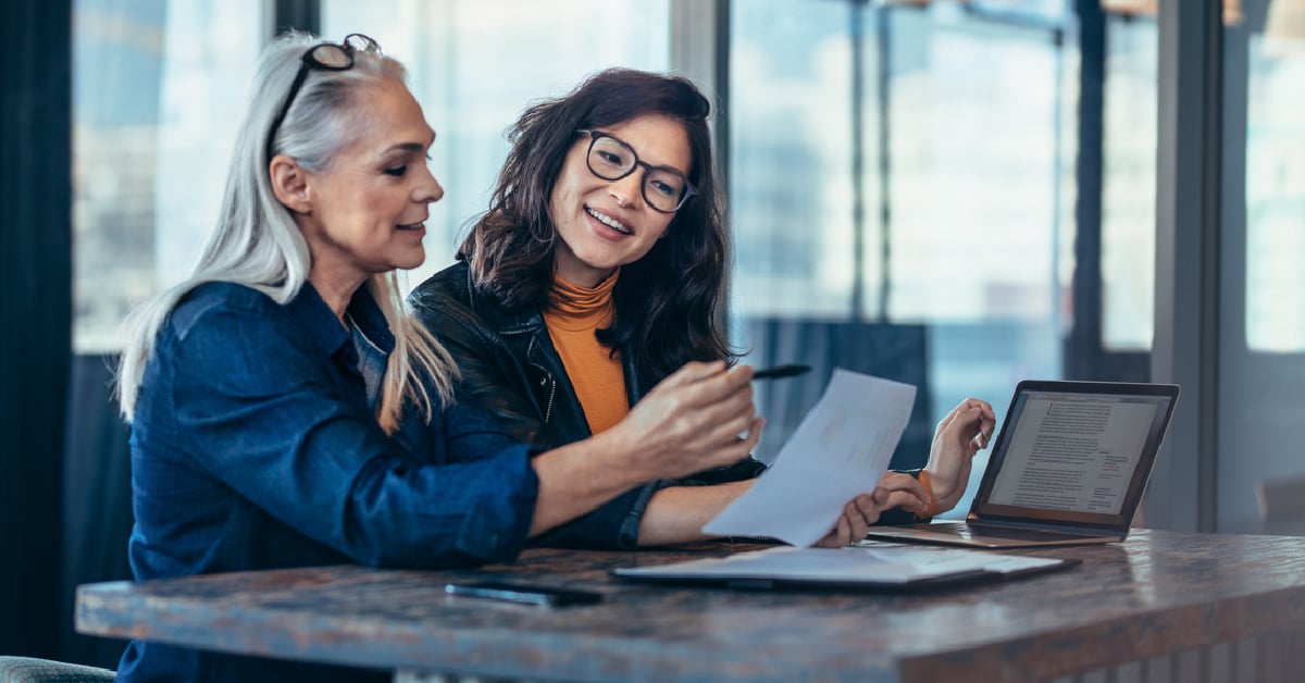 women looking at paper - employee benefits 