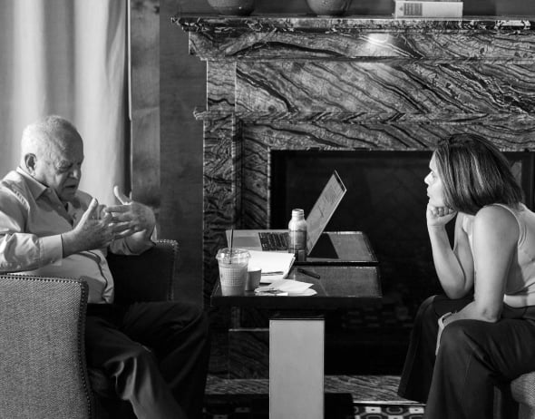 martin seligman speaking to woman at table