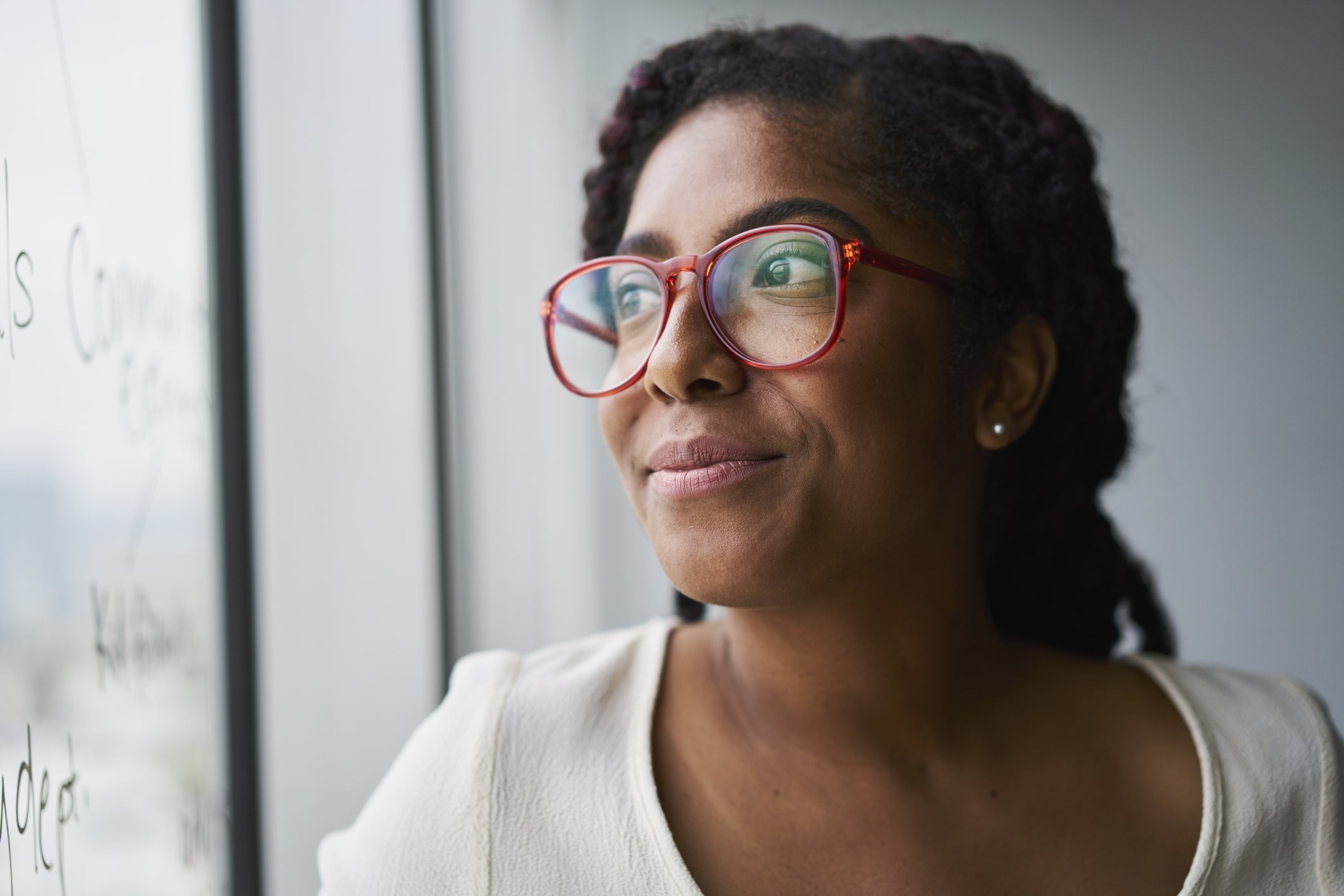 Portrait-of-cheerful-business-woman-looking-out-window-the-importance-of-knowing-yourself