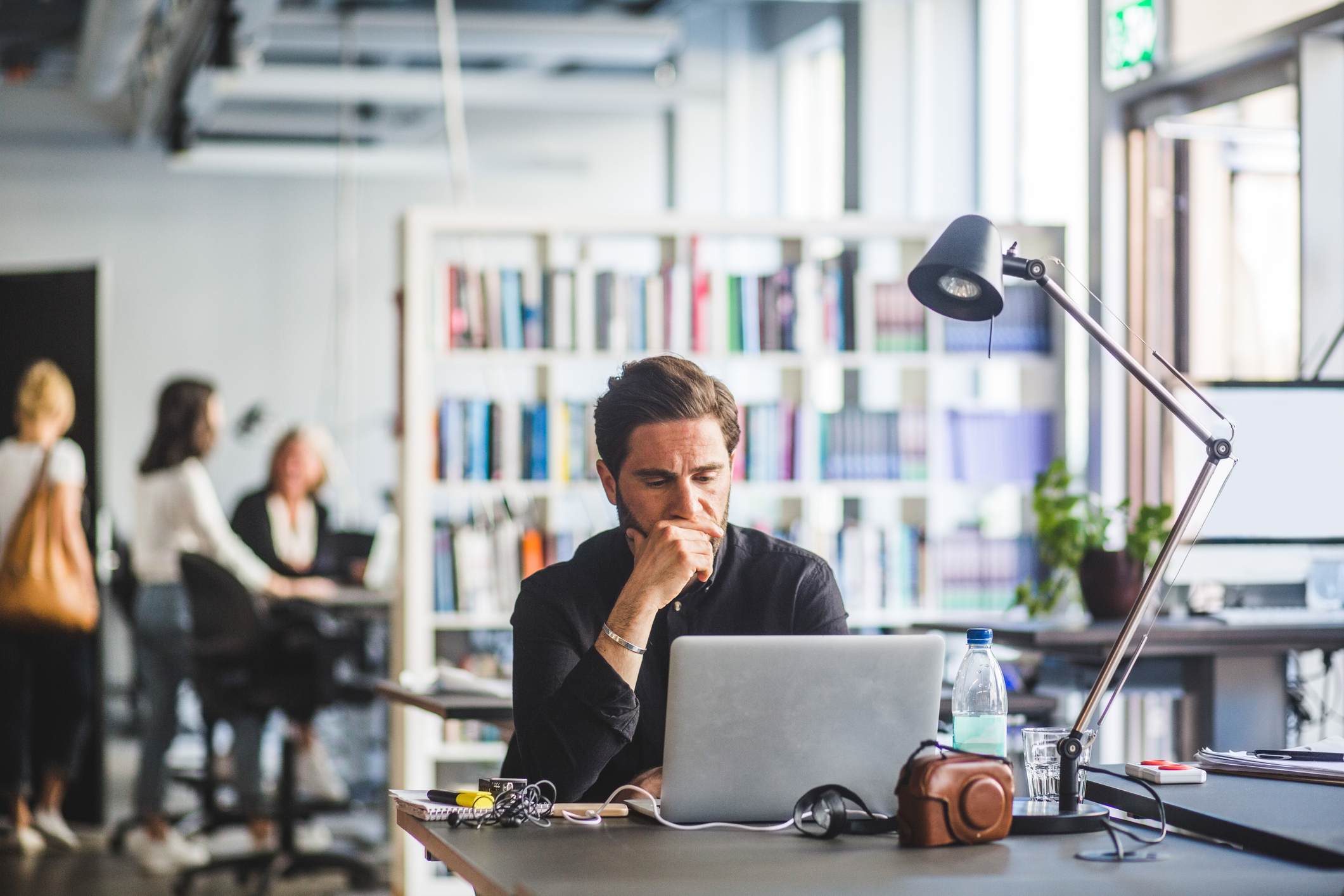 Worried-businessman-with-hand-on-chin-looking-at-laptop-what-to-do-if-you-don’t-get-a-promotion
