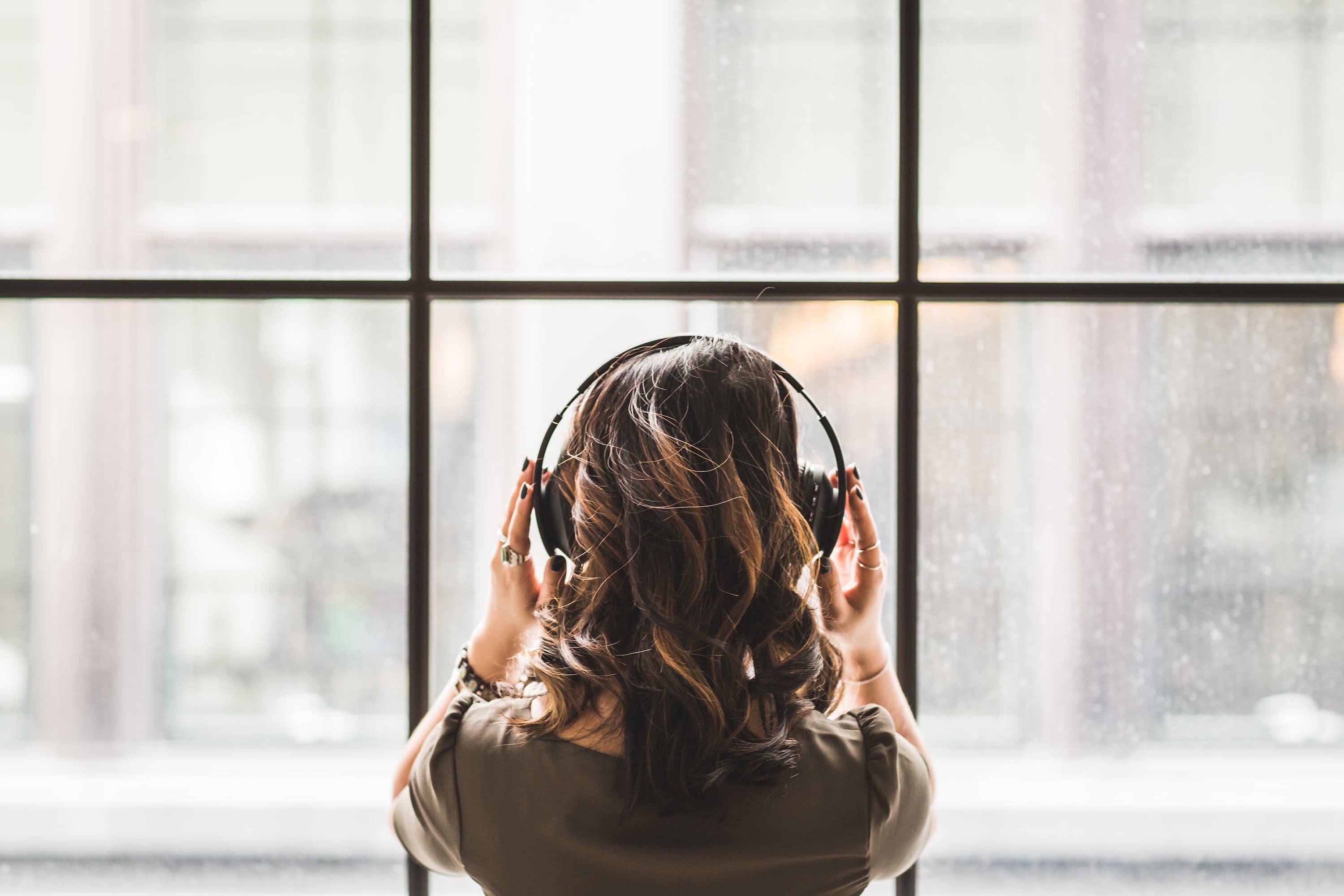 person-looking-out-window-listening-to-green-noise